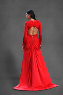 Red evening gown with open back on a gray background